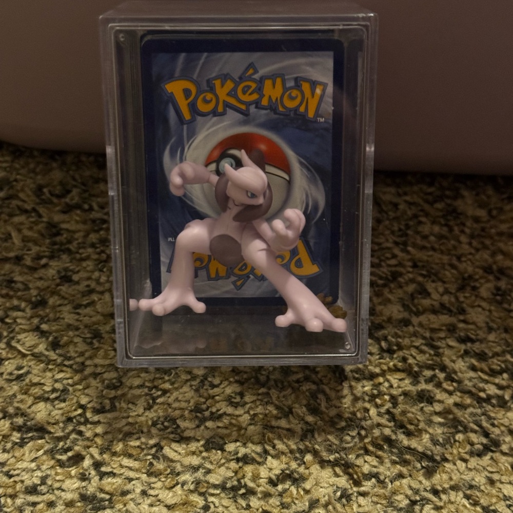 Pokemon Mewtwo Collectible with Card Display and large stack of Pokémon Cards